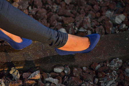 woman leg with jeans and railroadの写真素材