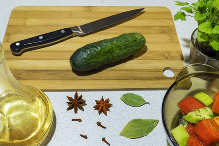 Cut cucumber with a knife on a bamboo boardの写真素材