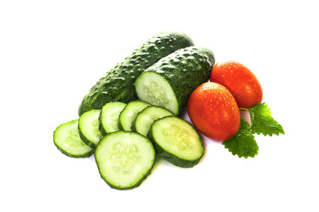 vegetables cucumbers and tomatoes on a white backgroundの写真素材