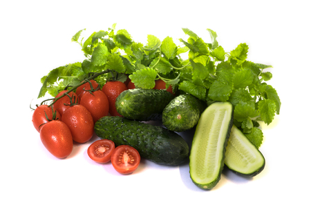 vegetables cucumbers and tomatoes on a white backgroundの写真素材