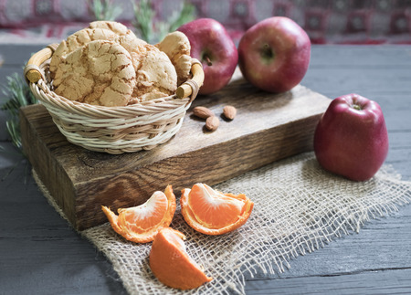 Almond cookies on a wooden plate with tangerinesの写真素材