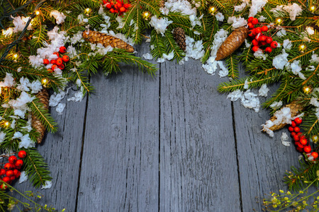 New Year's wreath from a green Christmas tree with cones on a wooden backgroundの写真素材