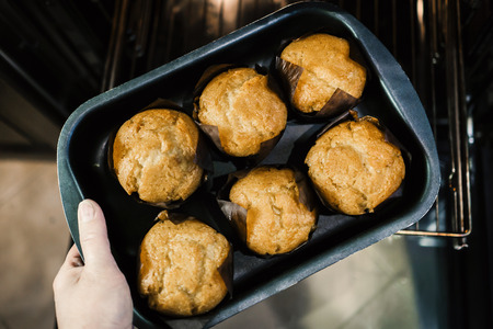 Six muffins on a baking sheet from the oven.の写真素材