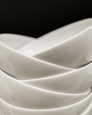 Ceramic bowls are stacked on top of each other. Tableware with a pile.の写真素材