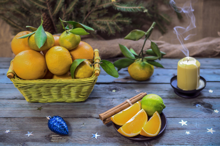 New Year's fruits in the basket. Oranges and tangerines for the festive table. Christmas still life of 2018の写真素材