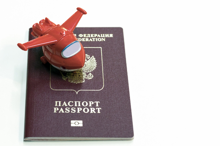 Passport and toy plane lie on the table. Symbol is a journey around the world.の写真素材