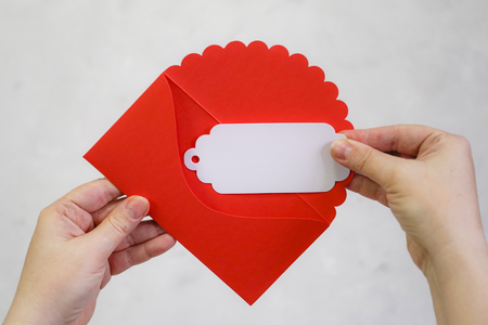 Female hands take out a letter from a red envelope. Valentine's Day. Love, relationships.の写真素材