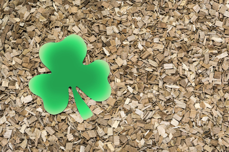 Shamrock clover made of paper on a background of wooden sawdust. St.Patrick 's Day.の写真素材