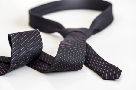 black tie knotted in a loop shape on a white background. The concept of not freedomの写真素材