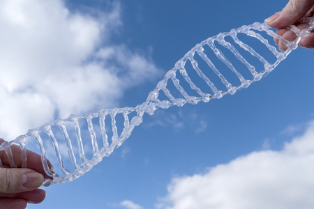 spiral dna against the blue sky with cloudsの写真素材