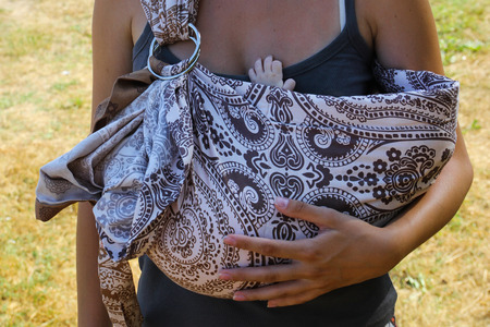 child pulls his hand to his momの写真素材