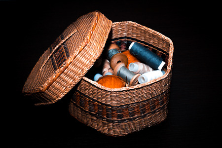 basket with thread on black backgroundの写真素材