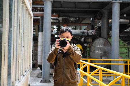 Kaohsiung, Taiwan - FEB 18, 2022: Man shooting with camera in Kaohsiung Ciaotou Sugar Refinery, Taiwanのeditorial素材