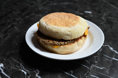 English muffin with pork chops and cheese close up.の写真素材