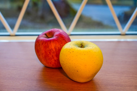 Japanese yellow and red apples on table close-upの写真素材
