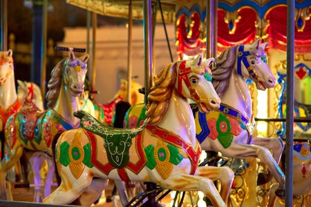 Old-fashioned roundabout with horsesの写真素材