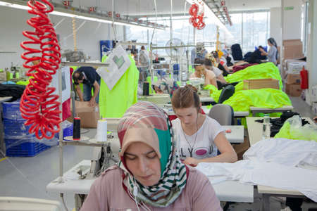 Ä°stanbul,Turkey - 8,12,2014:Unknown female workers working in a textile factoryのeditorial素材