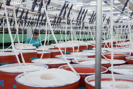Istanbul,Turkey - 08/26/2014: An unknown worker working in a textile factory.のeditorial素材