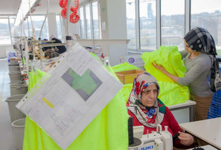Ä°stanbul,Turkey - 8,12,2014:Unknown female workers working in a textile factoryのeditorial素材