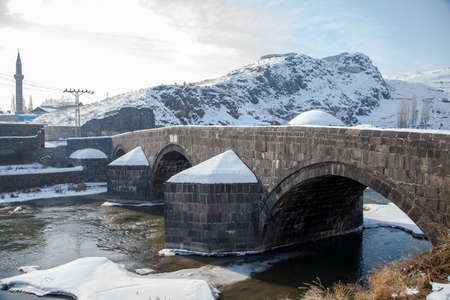 Kars, Turkey - 01/22/2016: This historical stone bridge built by the Ottoman Ruler Murat III. in 1579 collapsed due to flood and reconstructed by Karahanoglu Hac Ebubekirのeditorial素材