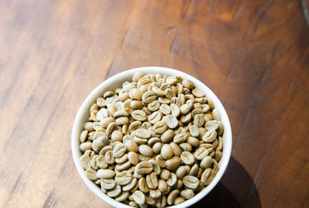 Green coffee beans in the cupの写真素材