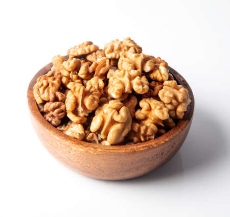 Walnuts in a bowl on a white backgroundの写真素材