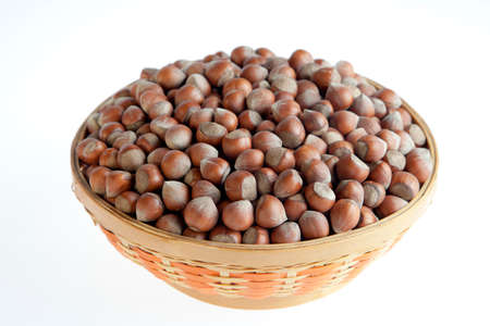 Hazelnut in bowl isolated on white backgroundの写真素材