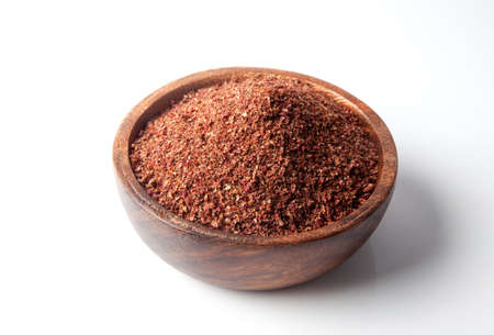 Powder sumac dried in bowl.On white backgroundの写真素材