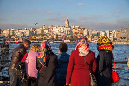 Eminonu,Ä°stanbul/Turkey - 5/11/2015:A conservative Turkish family and Galata Tower viewのeditorial素材
