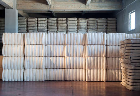 Raw cotton bales in textile factory.の写真素材