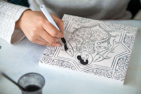 Kutahya,Turkey - 02-02-2017:Turkish tile art,Female tile artist paints porcelain at workshop.のeditorial素材