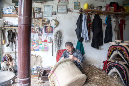 Manisa,Turkey - 04-23-2016:Craftsman making a saddle in his workshopのeditorial素材