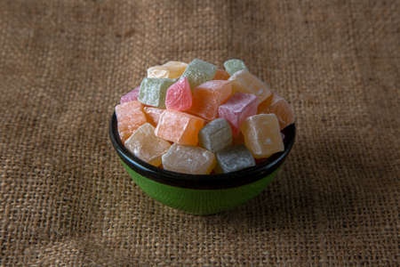 Traditional Turkish delight in a bowl on a burlap backgroundの写真素材