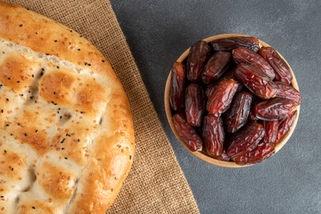 Traditional Ramadan pita on bright blue background.Holy bread for Muslims