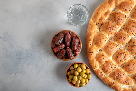 Traditional iftar table with dates, pita, green olivesの写真素材