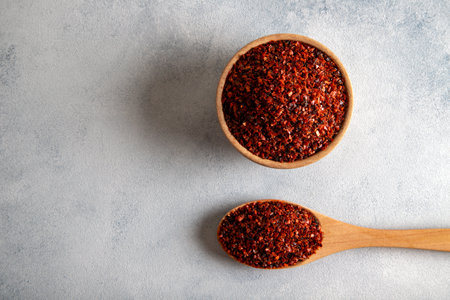 Pepper flakes,Red chili peppers in wooden bowl on light blue background