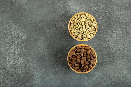 Coffee beans in wooden bowls on dark background, top viewの写真素材