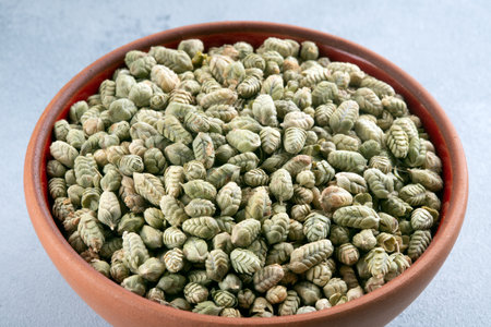 A bowlful of naturally dried thyme seeds on gray backgroundの写真素材