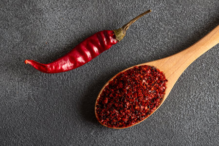 Red chili peppers.Red chili peppers in a wooden bowl on a gray background.Dried chili peppersの写真素材