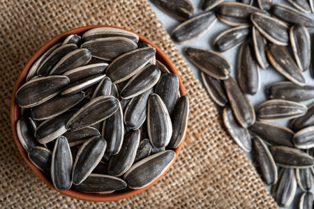 Sunflower seeds in a bowl on a wooden background. Close-up.の写真素材