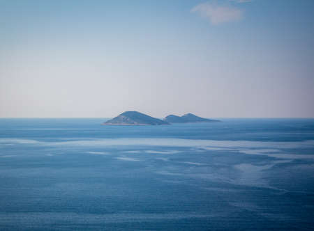 Islands in the rough sea. Islands in the middle of the blue sea. Distant islands in the middle of the sea.の写真素材