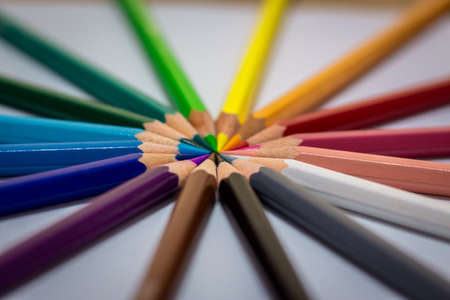 Opened orange pencil with orange pencil sharpener. Orange pencil chips. Orange pencil on a white background. High quality photoの写真素材