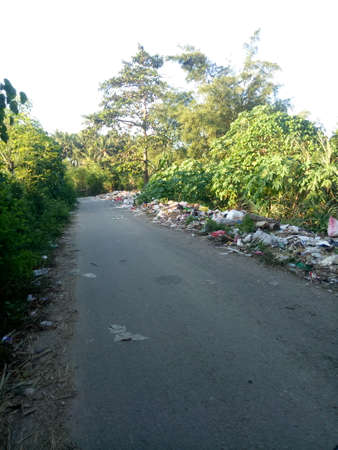a public road that has been turned into a garbage dump by irresponsible peopleの写真素材