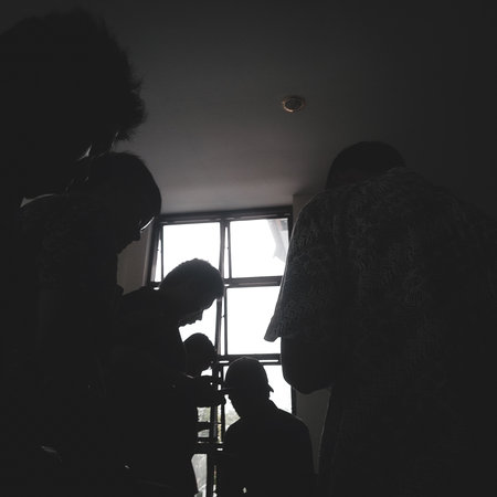 silhouettes of young men busy with their respective gadgetsの写真素材
