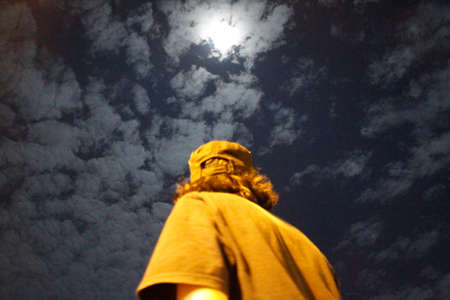a man standing against the background of the night sky.の写真素材