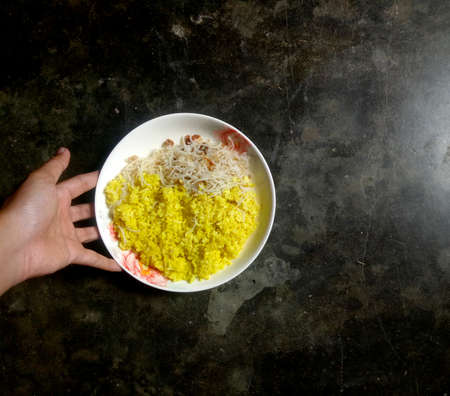 indonesian traditional yellow rice served with white plate
