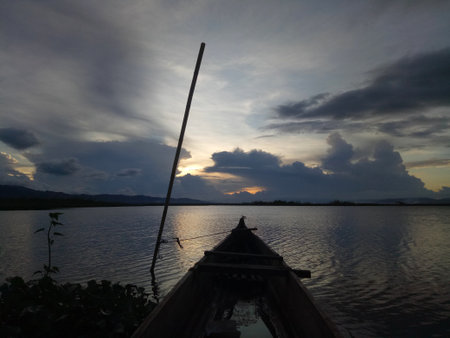 a traditional fishing boat anchored on the shore of Limboto Lake, Gorontalo.の写真素材