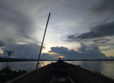 a traditional fishing boat anchored on the shore of Limboto Lake, Gorontalo.の写真素材