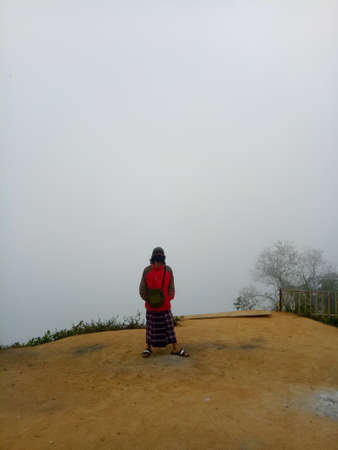 Man hiking in mountains. Travel Lifestyle adventure concept. Beautiful sky with clouds landscape.