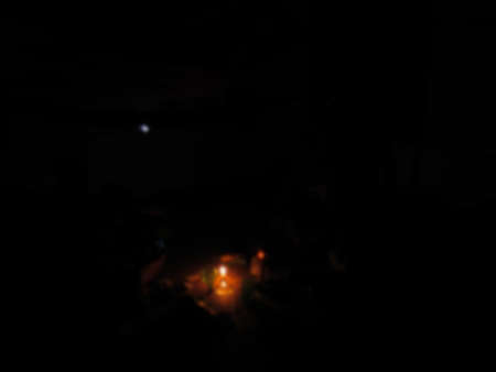 defocused on a burning candle illuminates the room at night